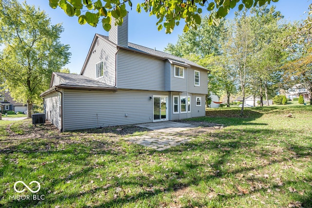 back of property featuring a lawn, cooling unit, and a patio