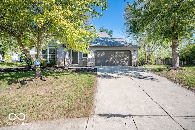 view of front of home featuring a front yard and a garage