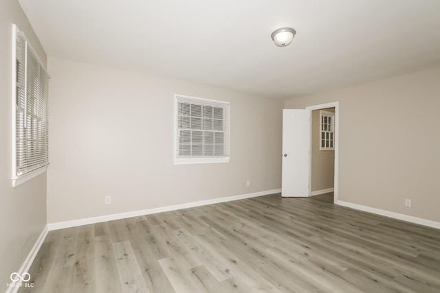 spare room featuring wood-type flooring