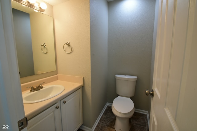 bathroom featuring tile patterned flooring, vanity, and toilet