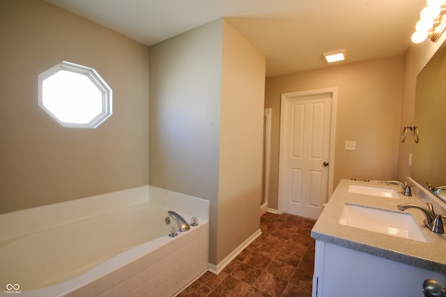 bathroom featuring vanity and tiled bath