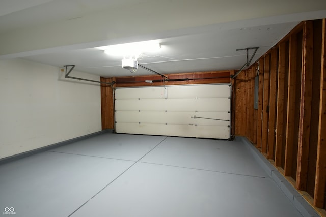 garage with a garage door opener and electric panel