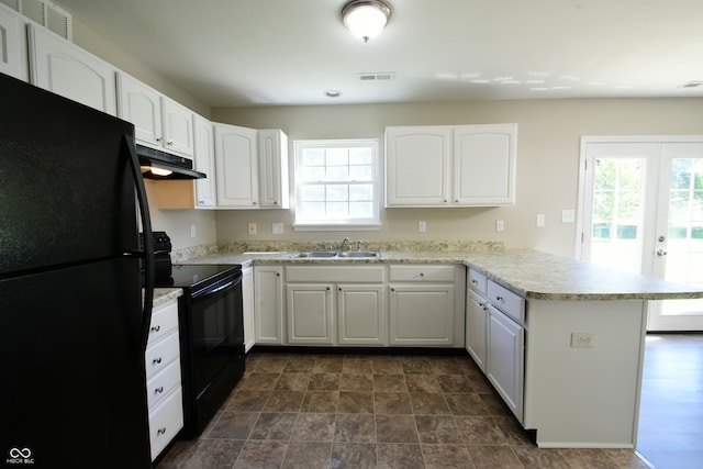 kitchen with white cabinets, sink, kitchen peninsula, and black appliances