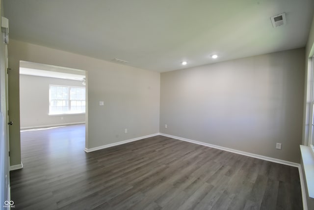 unfurnished room featuring dark hardwood / wood-style flooring