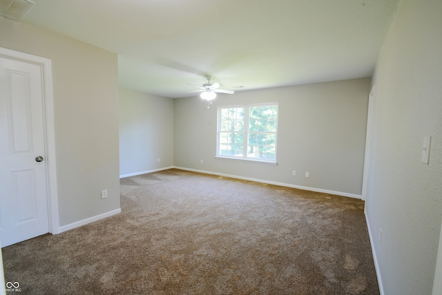 carpeted spare room with ceiling fan