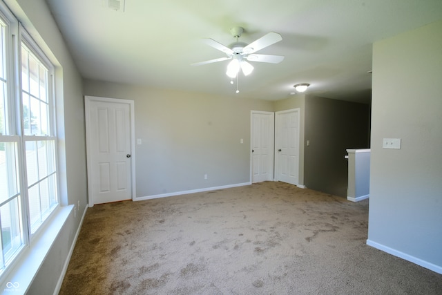 carpeted empty room with ceiling fan