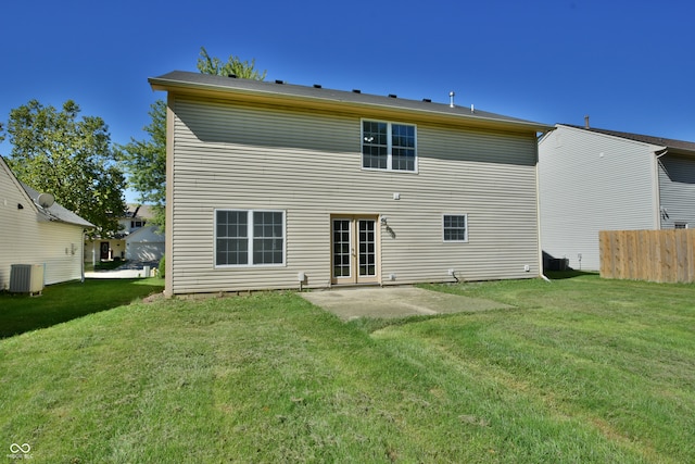 back of house featuring a yard, central air condition unit, and a patio area