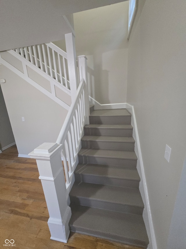 stairs with hardwood / wood-style flooring