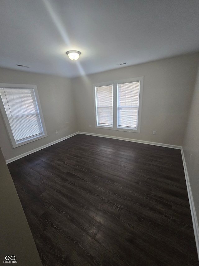 spare room with dark hardwood / wood-style floors