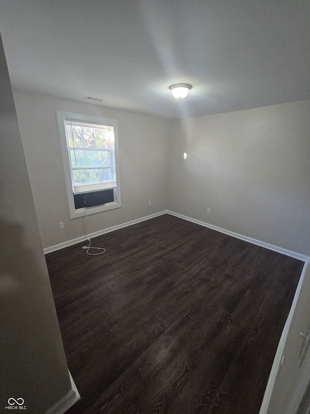 spare room featuring dark hardwood / wood-style flooring