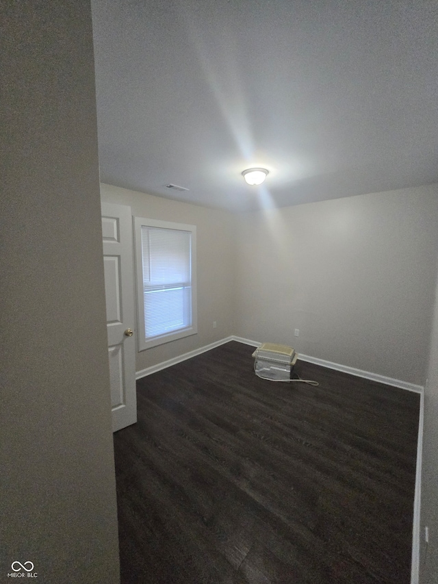 unfurnished room featuring dark hardwood / wood-style floors