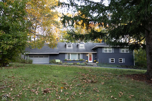 view of front of house featuring a garage and a front lawn