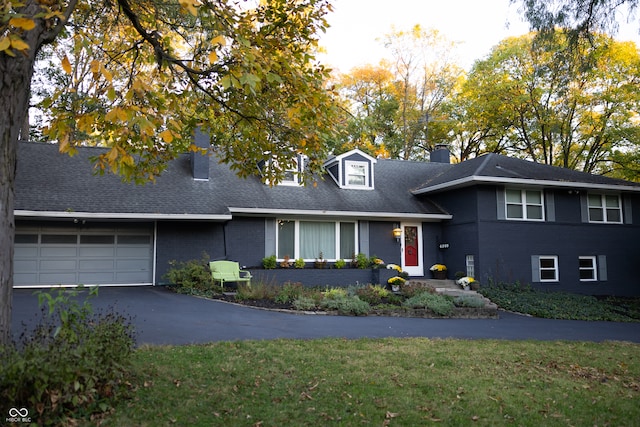 view of front facade with a front lawn and a garage