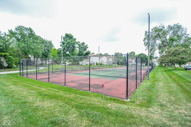 view of sport court with a yard