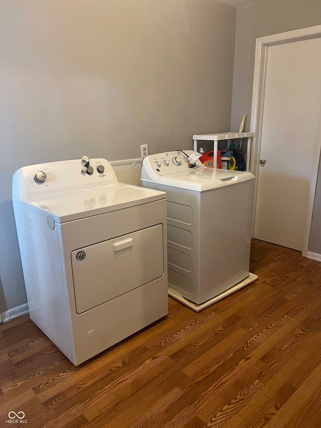 washroom with washer and dryer and hardwood / wood-style flooring