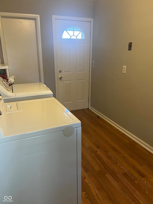 clothes washing area featuring independent washer and dryer and dark hardwood / wood-style flooring