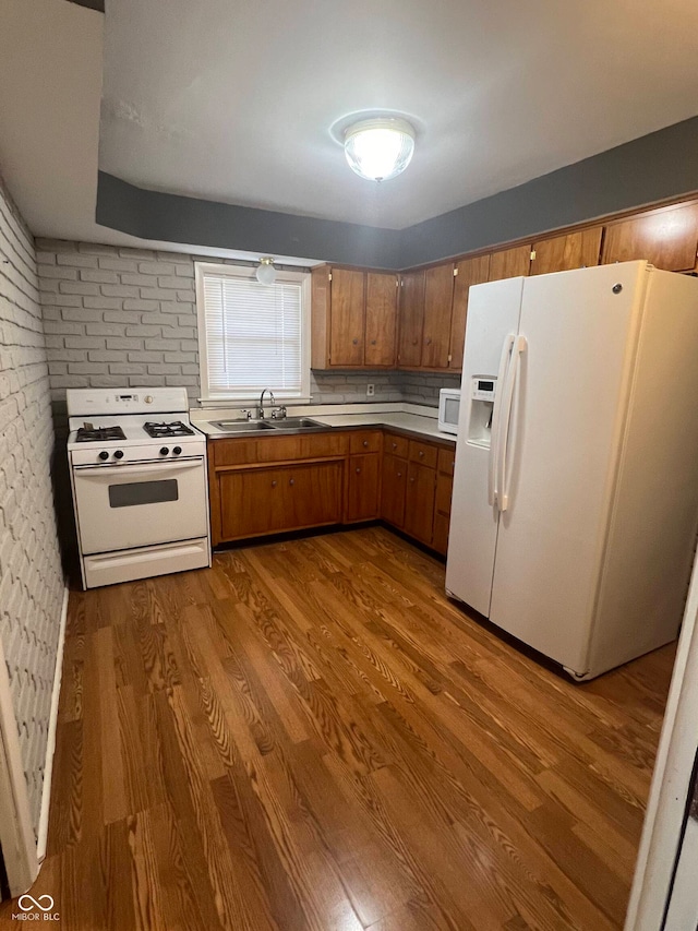 kitchen with light hardwood / wood-style flooring, decorative backsplash, sink, and white appliances