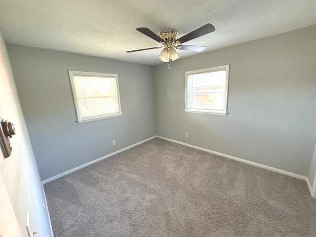 empty room featuring ceiling fan, carpet flooring, and plenty of natural light