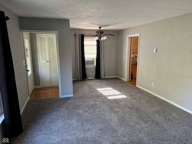 unfurnished bedroom featuring cooling unit, a closet, carpet, and ceiling fan