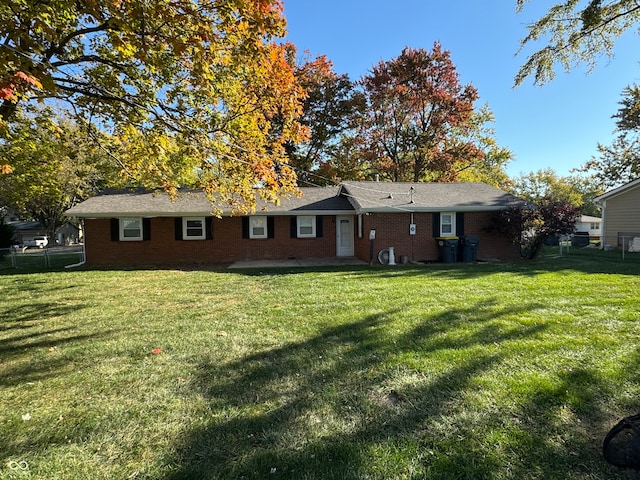 rear view of house featuring a lawn