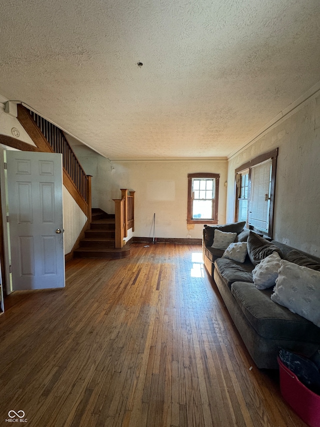 unfurnished living room featuring a textured ceiling and dark wood-type flooring