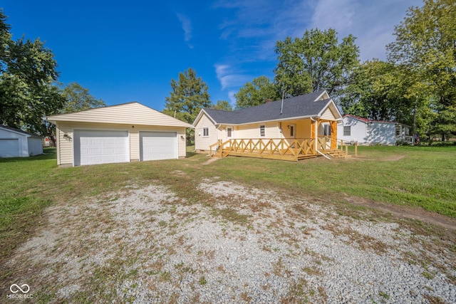 2682 E 150 S, Anderson, IN 46017 - rear view of property featuring an outdoor structure, a garage, a lawn, and a wooden deck