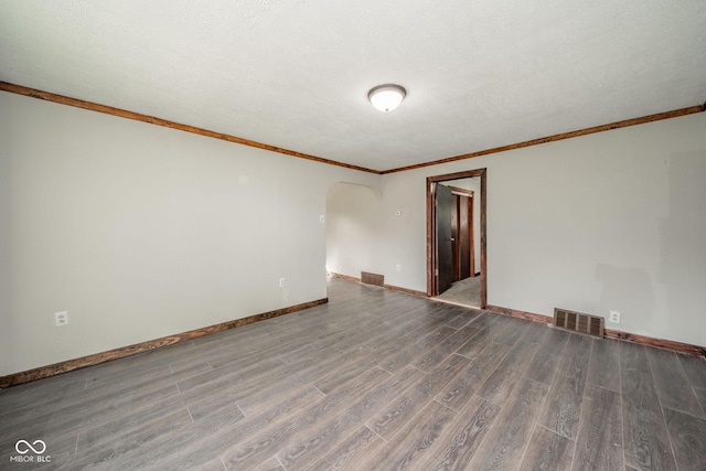 2682 E 150 S, Anderson, IN 46017 - unfurnished room featuring arched walkways, wood finished floors, crown molding, and a textured ceiling