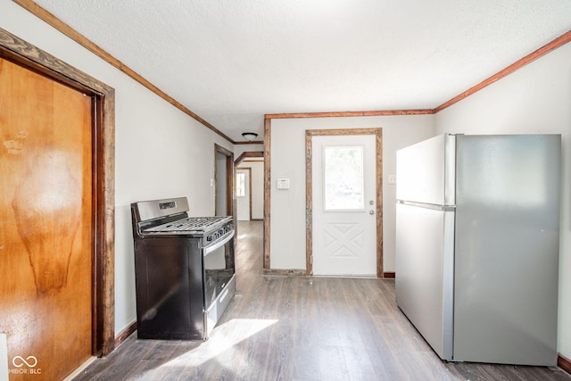 2682 E 150 S, Anderson, IN 46017 - kitchen with freestanding refrigerator, stainless steel gas stove, light wood-type flooring, and ornamental molding