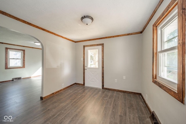 2682 E 150 S, Anderson, IN 46017 - entrance foyer with ornamental molding, arched walkways, dark wood-style flooring, and healthy amount of natural light