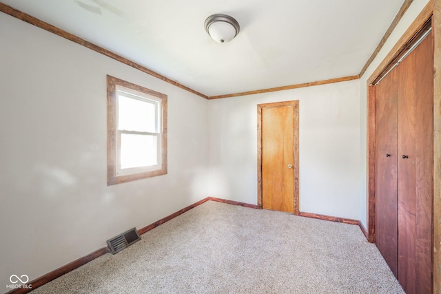 2682 E 150 S, Anderson, IN 46017 - unfurnished bedroom featuring carpet flooring, ornamental molding, and a closet