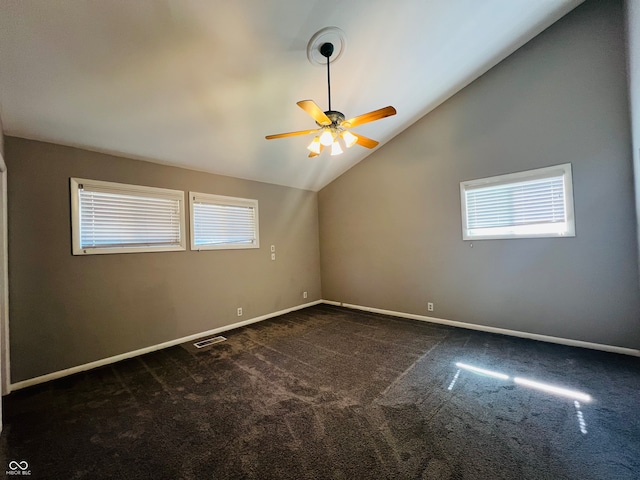 carpeted empty room with lofted ceiling, ceiling fan, and a wealth of natural light