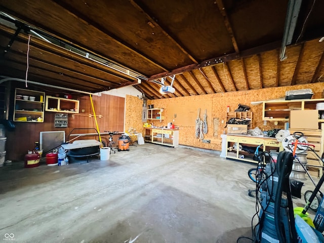 garage featuring a garage door opener and a workshop area