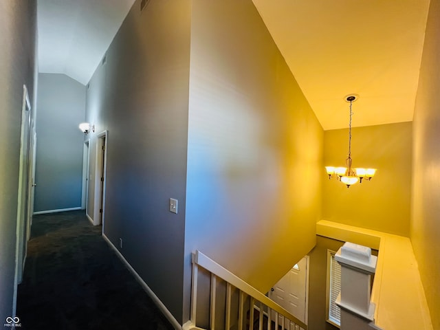 stairway featuring carpet floors, lofted ceiling, and a notable chandelier