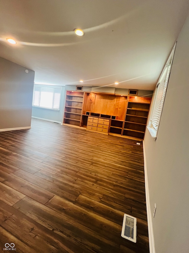 unfurnished living room featuring dark hardwood / wood-style flooring