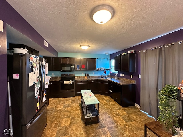 kitchen featuring dark brown cabinetry, a textured ceiling, sink, and black appliances