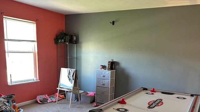 recreation room featuring plenty of natural light and carpet flooring