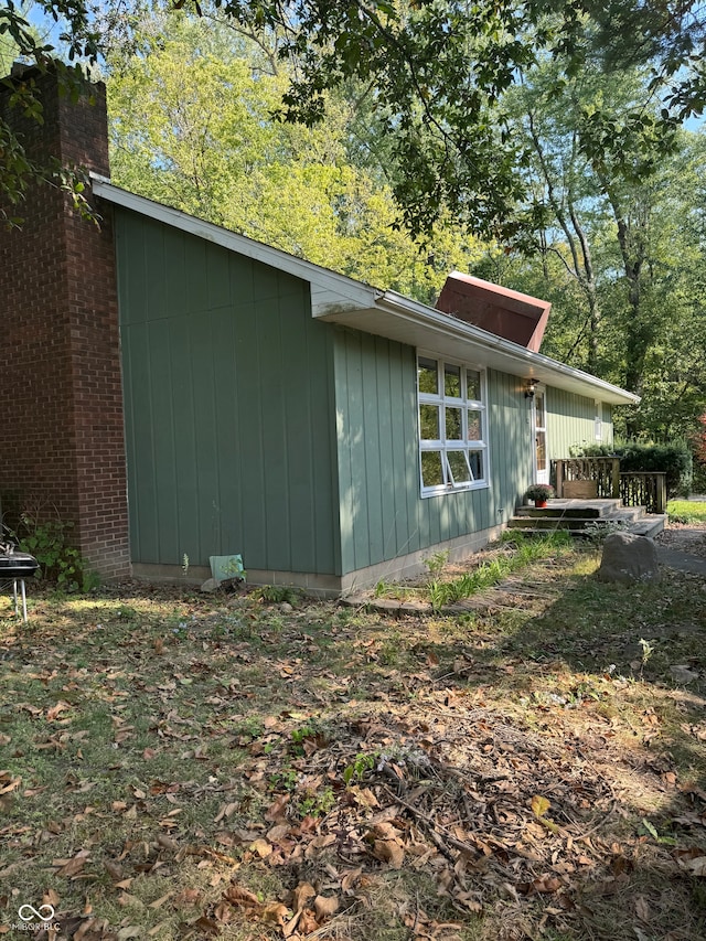 view of side of property with a wooden deck