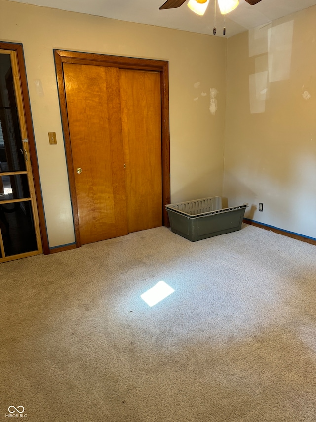 unfurnished bedroom with carpet flooring, ceiling fan, and a closet