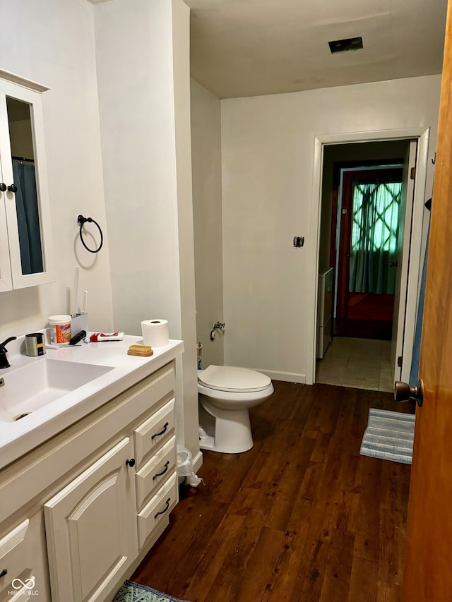 bathroom featuring hardwood / wood-style flooring, vanity, and toilet