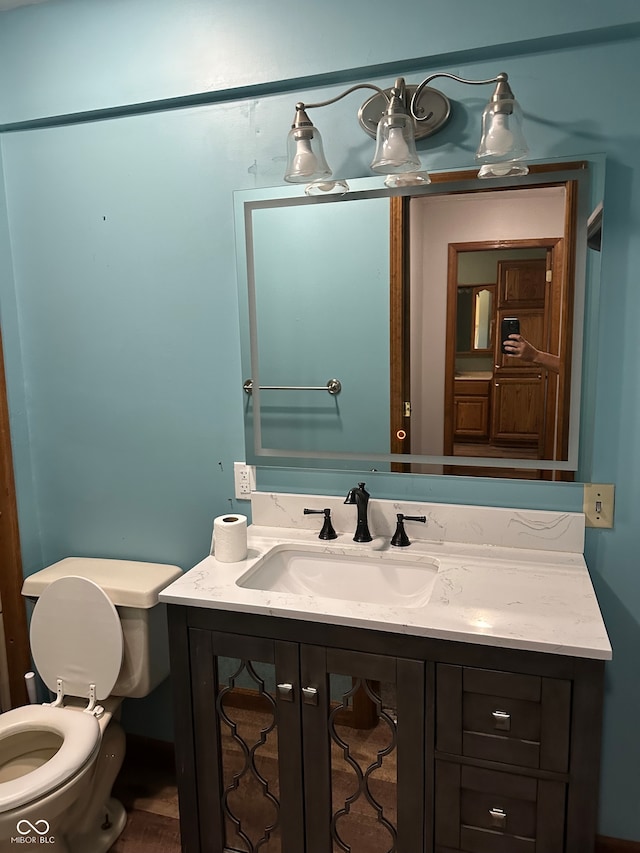 bathroom with vanity and toilet