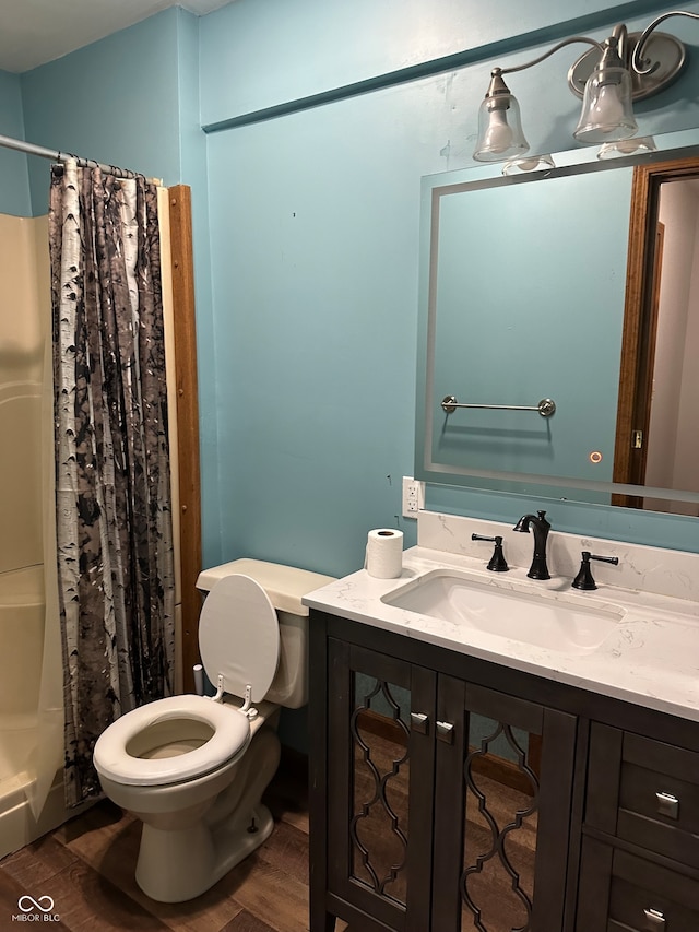 bathroom featuring hardwood / wood-style floors, vanity, toilet, and a shower with curtain