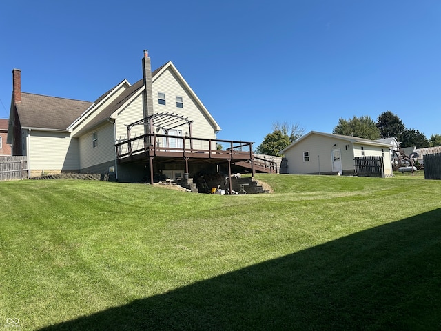 back of property featuring a deck and a lawn