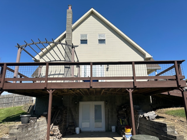 rear view of house featuring a deck and french doors