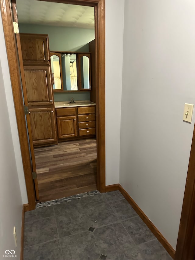 hallway featuring dark hardwood / wood-style floors and sink