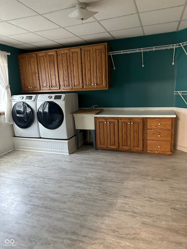 laundry room featuring cabinets and washing machine and dryer