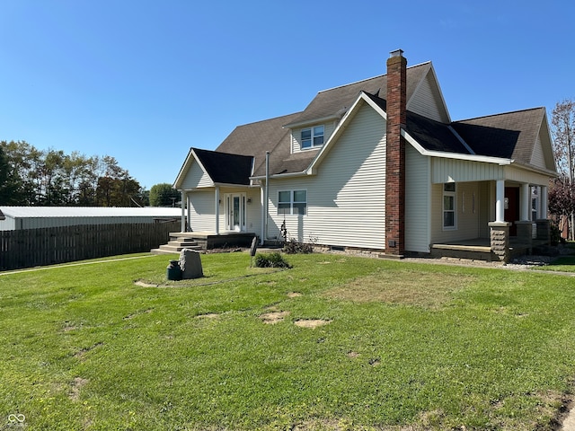 back of house with a lawn