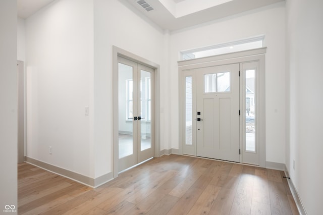 entryway featuring french doors and light hardwood / wood-style floors