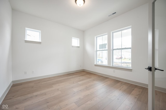 unfurnished room featuring light hardwood / wood-style floors