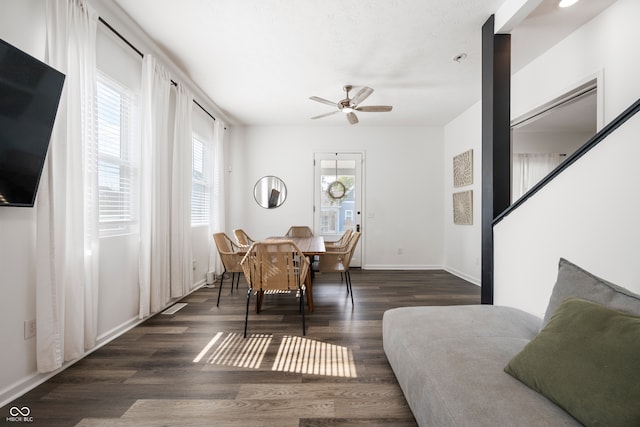 dining area featuring ceiling fan and dark hardwood / wood-style flooring