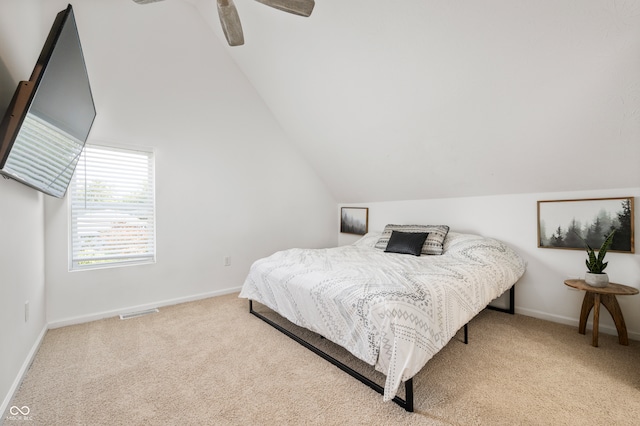 carpeted bedroom featuring lofted ceiling and ceiling fan